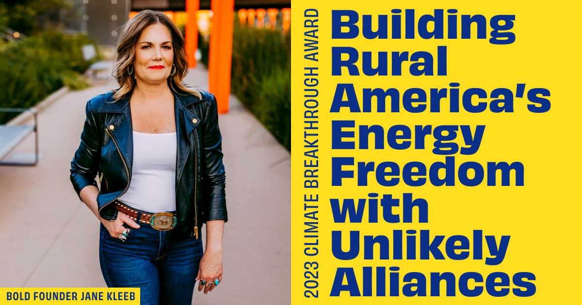 Photo of Jane Kleeb walking with a smile wearing her leather jacket, belt buckle, and blue jeans. Bold texts reads 2023 Climate Breakthrough Award: BUILDING RURAL AMERICA'S ENERGY FREEDOM WITH UNLIKELY ALLIANCES.